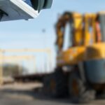 CCTV camera in the foreground of heavy construction machine